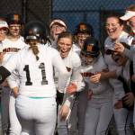 Monroe players cheer as McKenzie Schulz (11) runs to home plate after hitting a two-run home run to tie the game in the seventh inning against Edmonds-Woodway on March 21, 2017, in Monroe. The Bearcats went on to beat Edmonds-Woodway 3-2 in extra innings. (Andy Bronson / The Herald)