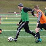 Snohomish boys soccer coach Matt Raney (center) participates in a drill with the team during practice on Monday. Raney takes over this season for Dan Pingrey, who coached the varsity team for 18 years. (Andy Bronson / The Herald)