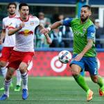 Seattle Sounders forward Clint Dempsey (right) drives past New York Red Bulls midfielder Sacha Kljestan during the first half of their MLS match Sunday in Seattle. (AP Photo/Ted S. Warren)
