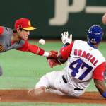 Cuba&rsquo;s Yurisbel Gracial steals second base as the ball gets away from China second baseman Du Xiaolei during the second inning of their first-round game Wednesday at the World Baseball Classic in Tokyo. (AP Photo/Koji Sasahara)