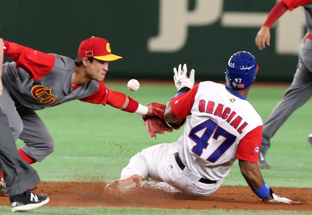 Cuba&rsquo;s Yurisbel Gracial steals second base as the ball gets away from China second baseman Du Xiaolei during the second inning of their first-round game Wednesday at the World Baseball Classic in Tokyo. (AP Photo/Koji Sasahara)