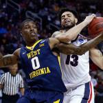 Gonzaga guard Josh Perkins (13) grabs a rebound next to West Virginia guard Teyvon Myers during the second half of an NCAA Tournament game Thursday in San Jose, Calif. (AP Photo/Tony Avelar)