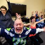 Larry Berg (nearest) enthusiastically helps Willow Place activity manager Rachel Hawkins (center) lead a modified yoga class early Tuesday at Quilceda Community Services in Marysville. (Dan Bates / The Herald)