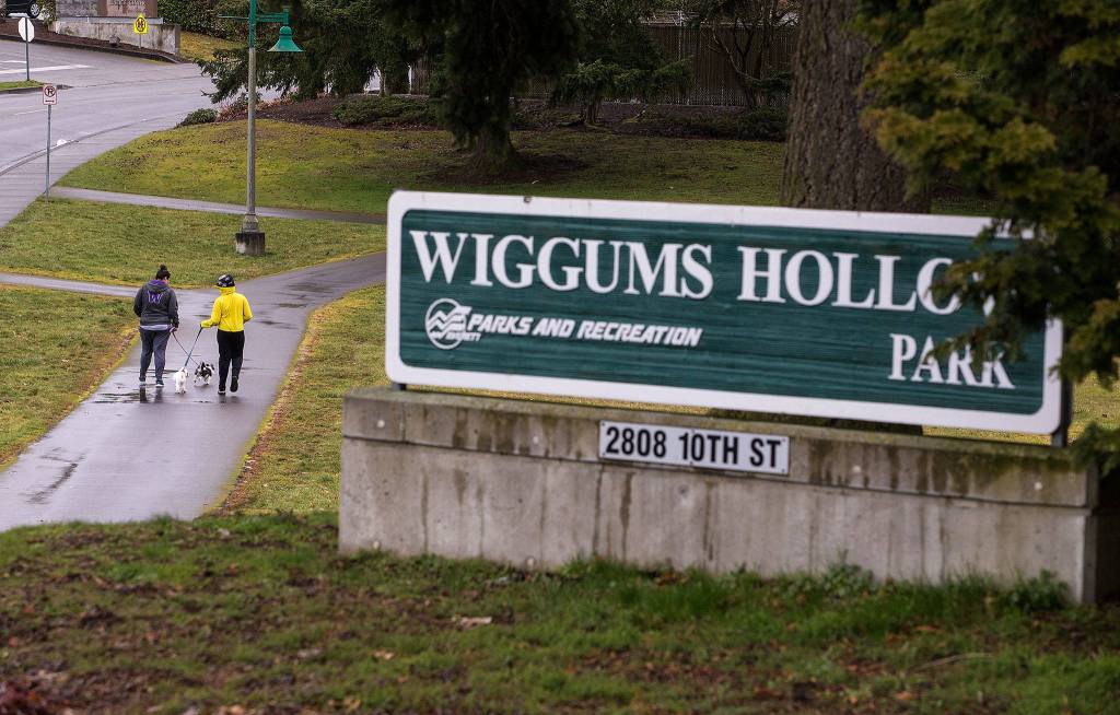 Two women walk dogs at Wiggum&rsquo;s Hollow Park, named for Arnie Wiggum, on Friday n Everett. A character on the animated TV show &ldquo;The Simpsons&rdquo; is also named for the Everett native. (Andy Bronson / The Herald)