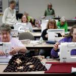 Linda Lambert (left), of Everett, and Vickie Sawade, of Snohomish, sew tote bags with other members of the Snohomish County Sewing and Textile Advisors at McCollum Park in Everett on March 17. The completed bags all went to Safe Place, an Everett shelter for homeless children. (Ian Terry / The Herald)