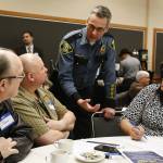 Tom Davis, Lynnwood&rsquo;s Chief of Police, chats with a group including Phil (center left) and Chancey Homan (right), of Mercy Seat Christian Fellowship in Lynnwood, during the first &ldquo;Cops and Clergy&rdquo; meeting at the Lynnwood Convention Center on Feb. 8. The meeting was meant to spur conversation and partnership between local law enforcement and faith leaders in the community. (Ian Terry / The Herald)