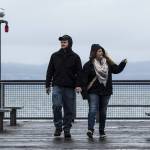 Kaitlin Vos and Zach Jacoby walk along the pier at Kayak Point Park in Stanwood on Tuesday. The pair, who are from Marshall, Minnesota, are in Stanwood visiting Vos&rsquo; family. (Ian Terry / The Herald)