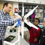 Students Noah Henok (center right), 11, and Cris Martinez, 11, get help attaching the blades of their homemade wind turbine from teacher Jody Wallis at Chase Lake Elementary School in Edmonds on Tuesday. Fourth- and fifth-graders at the school are learning about renewable energy through a national program called the KidWind Challenge. (Ian Terry / The Herald)