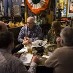 Trivia team &ldquo;Fighting Finnegans&rdquo;, including members Derek (center) and Maureen Reading consider a question during Tuesday night trivia at Shawn OՄonnellճ American Grill & Irish Pub in Everett on March 7. (Ian Terry / The Herald)