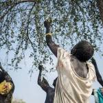Women pick leaves from a tree that they will later cook for dinner in the small village of Apada, near Aweil in South Sudan. (Mackenzie Knowles-Coursin/UNICEF via AP)