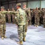 Capt. Brandon Myers (left), of Snohomish, and 1st. Sgt. Frederick Wahlgren case the 176th Engineer Company guideon during the Transfer of Authority Ceremony held at Camp Buerhing, Kuwait, on Dec. 12. This action signifies the completion of the mission and the transfer of authority to the 1156th Engineer Company of the New York National Guard. (U.S. Army Photo by Spc. Valentina Aguilar)