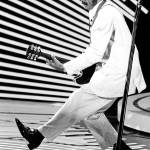 In this April 4, 1980 photo, guitarist and singer Chuck Berry performs his &ldquo;duck walk&rdquo; as he plays his guitar on stage. (AP Photo)