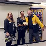 Clothes For Kids representatives Lisa George and Yuliana Flores-Montes receive a $2,000 check from Lynnwood Kiwanis President Ron Swengel at the March 2 Kiwanis meeting. (Contributed photo)