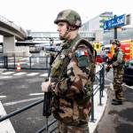 Soldiers patrol at Orly airport, south of Paris, on Saturday. Soldiers at the busy airport shot and killed a man who wrestled one of their colleagues to the ground and tried to steal her rifle Saturday, officials said. (AP Photo/Kamil Zihnioglu)