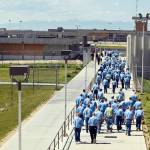 In this 2010 photo, inmates walk to the dinning hall from their cell block at the Idaho State Correctional Institution outside Boise, Idaho. Idaho inmates are asking a federal judge to hold the state in contempt after they say prison officials repeatedly violated a settlement plan in a long-running lawsuit over health care, leading to serious injuries and even the deaths of some prisoners. (Charlie Litchfield / AP File)