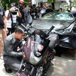In this Sept. 3, 2012, photo, a Ferrari that was driven by Vorayuth Yoovidhya, a grandson of late Red Bull founder Chaleo Yoovidhya, and a motorcycle, both involved in an accident, are displayed by police in Bangkok. (Thai Daily News via AP)