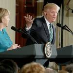 President Donald Trump, joined by German Chancellor Angela Merkel (left), speaks during a joint news conference in the East Room of the White House in Washington on Friday. (AP Photo/Andrew Harnik)