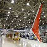 Boeing 737 MAX winglets, which sweep up and down from the wingtip and differ from the current 737 model with its single upward wingtip sweep, stand already painted in the Lion Air livery as the wing is assembled at Boeing&rsquo;s airplane production facility Monday, Feb. 13, in Renton. (AP Photo/Elaine Thompson, file)