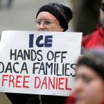 In this Feb. 17 photo, a protester holds a sign that reads &ldquo;ICE Hands Off DACA Families Free Daniel,&rdquo; during a demonstration in front of the federal courthouse in Seattle. (AP Photo/Ted S. Warren, file)
