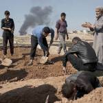 Relatives and friends bury the body of Khadeer Hassan, who was killed during fighting between Iraqi security forces and Islamic State militants, on the western side of Mosul, Iraq, on Saturday, March 25. (AP Photo/Felipe Dana)