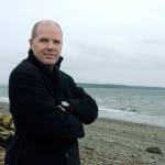In a March 17 photo, filmmaker Ian Hinkle poses in Port Townsend. Hinkle, a former resident of Port Townsend, returned to show his 2014 documentary &ldquo;Reaching Blue&rdquo; about the effects of climate change on the Salish Sea. (Cydney McFarland/Peninsula Daily News via AP)
