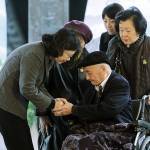 Taiwanese President Tsai Ing-wen (left) gives her regards to 96-years-old victim Fu Jen-hung during a memorial service marking the 228 Incident in Taipei, Taiwan, on Tuesday, Feb. 28. (AP Photo/Chiang Ying-ying)