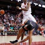 USC&rsquo;s Chimezie Metu (top) reacts after blocking a shot by Washington&rsquo;s Carlos Johnson during the first half of a game March 4, 2017, in Los Angeles. (AP Photo/Jae C. Hong)