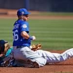 Mariners right fielder Taylor Motter (rear) steals second base ahead of the tag from Cubs shortstop Munenori Kawasaki (66) during the second inning of a spring training game March 10, 2017, in Peoria, Ariz. (AP Photo/Ross D. Franklin)