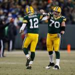 Packers quarterback Aaron Rodgers (12) celebrates with guard T.J. Lang (70) after throwing a touchdown pass to wide receiver Randall Cobb during the first half of an NFC wild-card NFL game Jan. 8, 2017, in Green Bay, Wis. (AP Photo/Matt Ludtke)
