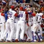 The Dominican Republic&rsquo;s Nelson Cruz (23) is congratulated by his teammates after hitting a three-run home run during the eighth inning against the United States in a first-round game of the World Baseball Classic on March 11, 2017, in Miami. The Dominican Republic won 7-5. (AP Photo/Lynne Sladky)