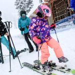 Isabelle Youn tries on her father&rsquo;s skis with parents Andrew Carlson, left, and Susan Chong looking on Wednesday morning at the Stevens Pass Washington Ski Resort in Skykomish on November 30, 2016. (Kevin Clark / The Herald)