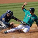 Mariners&rsquo; Mitch Haniger is tagged out at home by Milwaukee Brewers catcher Manny Pina in the second inning of a spring training baseball game Thursday in Peoria, Ariz. (AP Photo/Charlie Riedel)
