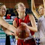 Snohomish&rsquo;s Kyra Beckman (center) goes up for a shot with Mercer Island&rsquo;s Anna Luce (left) and Jessie Stenberg defending during a 3A Hardwood Classic semifinal game Friday at the Tacoma Dome. Snohomish lost to Mercer Island 60-51. (Kevin Clark / The Herald)