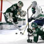 Silvertips goalie Carter Hart (left) and defenseman Kevin Davis try to stop Seattle&rsquo;s Austin Strand in the second period on March 10, 2017, in Kent. (Kevin Clark / The Herald)