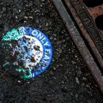 Informational signs near drains in Mill Creek have been covered and most are now illegible. (Ian Terry / The Herald)