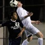 Snohomish&rsquo;s Jason Fairhurst heads the ball against Glacier Peak&rsquo;s Mark Granados during a match on March 17, at Veteran Memorial Stadium in Snohomish. (Kevin Clark / The Herald)