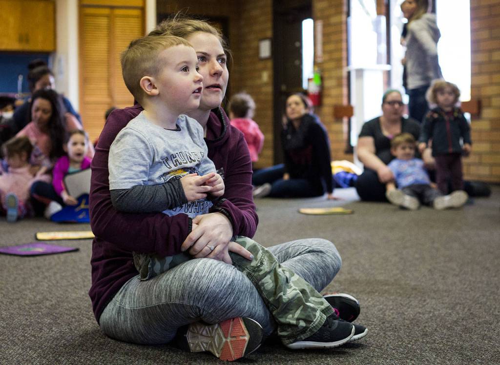 Allie Laplaunt and her 2-year-old son, Landon, listen to a story during Ready Readers: Toddler Storytime hosted by the Lake Stevens Library at the neighboring Community Center on Tuesday. The library utilizes the large space in the community center for events and readings. (Daniella Beccaria / The Herald)