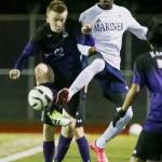 Kamiak&rsquo;s Sebastian Munroe, left, and Mariner&rsquo;s Bakary Dibba vie for a loose ball in the first half Friday night at Mariner High on March 24, 2017. (Kevin Clark / The Herald)