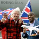 Richard Branson reacts after presenting Lance Lyttle, Managing Director of the Port of Seattle, with a model airplane after Branson arrived on a flight from London to Seattle on Monday at Sea-Tac Airport. (AP Photo/Ted S. Warren)