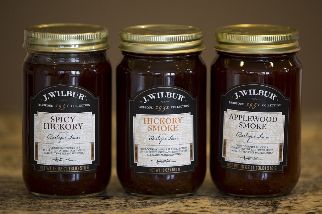 J. Wilbur Food&rsquo;s barbecue sauce varieties (from left) Spicy Hickory, Hickory Smoke and Applewood Smoke. (Ian Terry / The Herald)