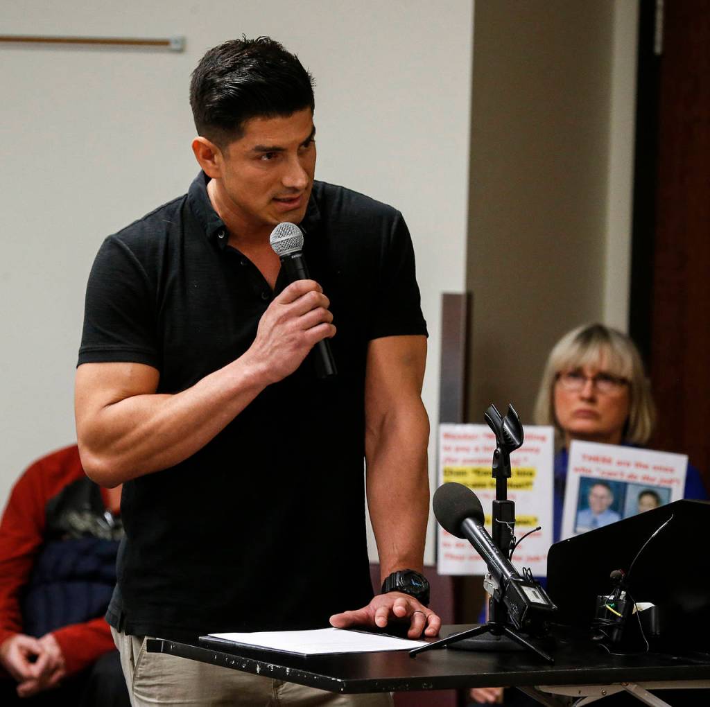 Snohomish County District 1 firefighter Moi Castellon addresses the commission. (Ian Terry / The Herald)