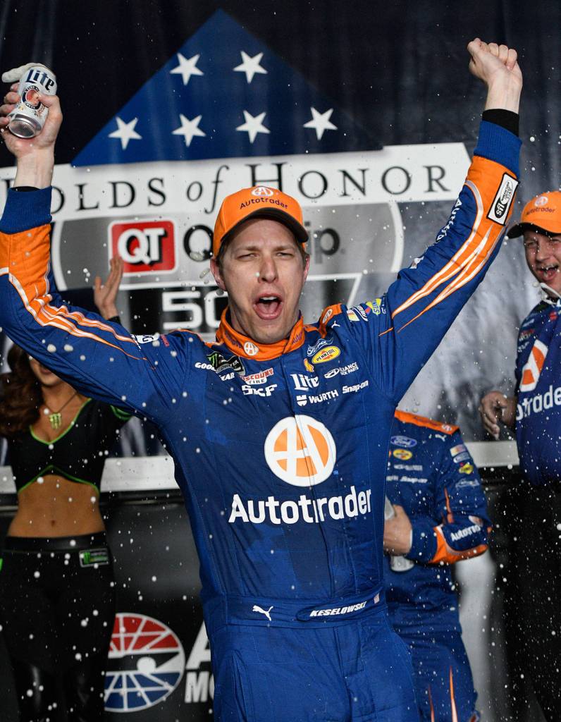 Brad Keselowski celebrates in Victory Lane after winning a NASCAR Monster Cup series auto race at Atlanta Motor Speedway in Hampton, Ga., Sunday, March 5. (AP Photo/John Amis)