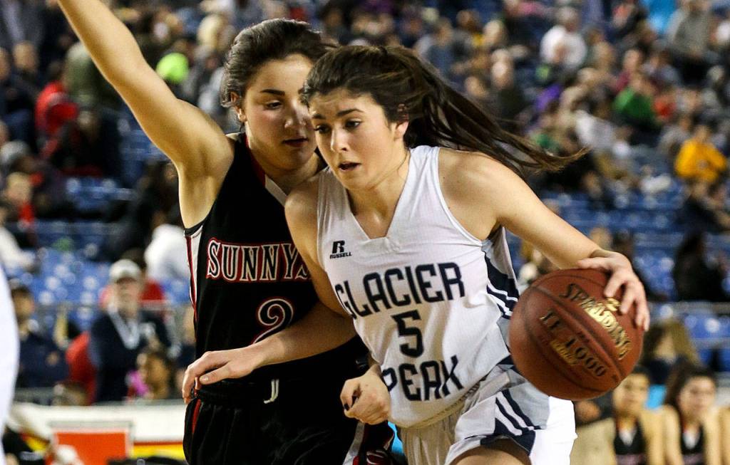 Glacier Peak&rsquo;s Samantha Fatkin drives the lane with Sunnyside&rsquo;s Chastitee Garza defending during the 2017 4A Hardwood Classic state tournament Thursday night at the Tacoma Dome on March 02, 2017. Glacier Peak won 48-47.(Kevin Clark / The Herald)