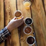 A customer tries a flight of beers and one cider at Lake Stevens Brewing Company, the first brewery in the city, on Thursday, Feb. 23, in Lake Stevens. (Andy Bronson / The Herald)
