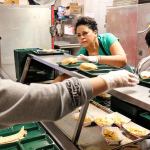 Grace Chang, Lisa Gaines and Kowin Edward prepare for first lunch Thursday morning at Challenger Elementary School in Everett. (Kevin Clark / The Herald)