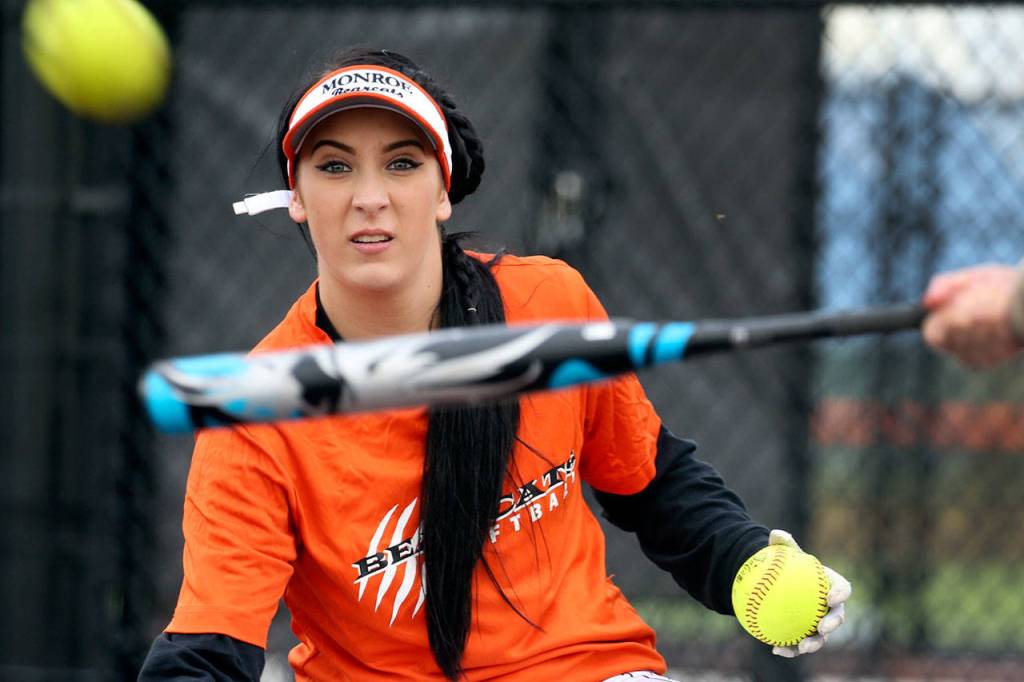 Monroe softball player Morgan Allen tosses a pitch during practice March 10. (Kevin Clark / The Herald)