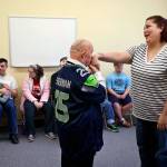 QCS caregiver Jamie Denton is rewarded with chivalry from Larry Berg for being a good sport Tuesday following a yoga program. (Dan Bates / The Herald)