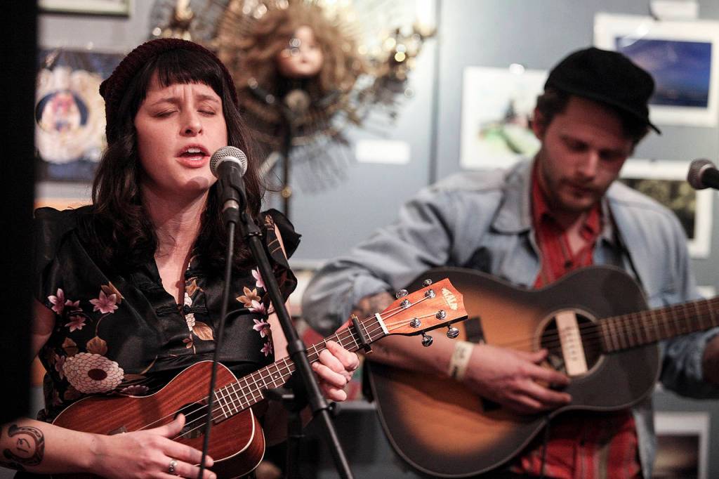 Christa and Richard Porter, of The Porters, play a set at the Black Lab Gallery during the Fisherman&rsquo;s Village Music Festival in Everett on Friday. (Ian Terry / The Herald)
