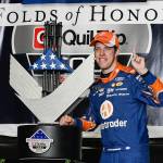 Brad Keselowski poses with the trophy in victory lane after winning a NASCAR Monster Cup series auto race at Atlanta Motor Speedway in Hampton, Ga., Sunday, March 5. (AP Photo/John Amis)