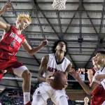 Nathan Hale&rsquo;s P.J. Fuller (center) gathers a rebound as Stanwood&rsquo;s A.J. Martinka (0) soars through the air during a 3A state tournament game March 2, 2017, at the Tacoma Dome. (Kevin Clark / The Herald)